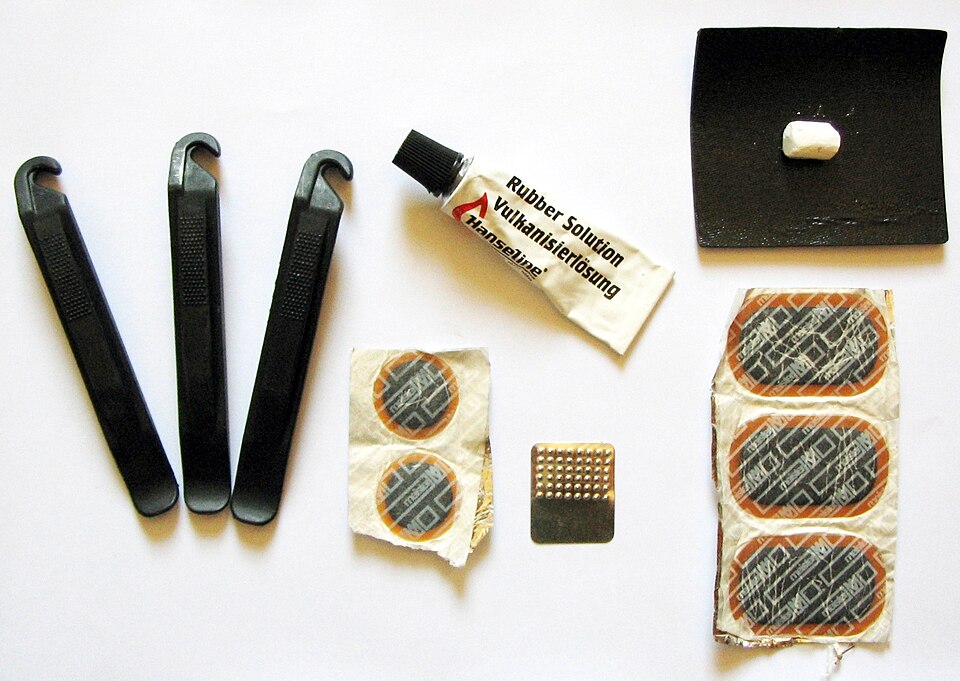 A puncture repair kit: three tire levers, rubber solution, patches and a small scuffer